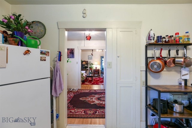 kitchen with white fridge and wood-type flooring