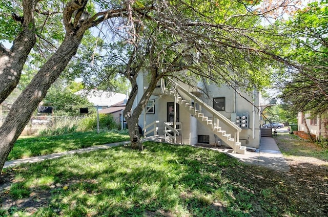 325 N 3rd St, Livingston, MT 59047 - back of property featuring stucco siding and stairway