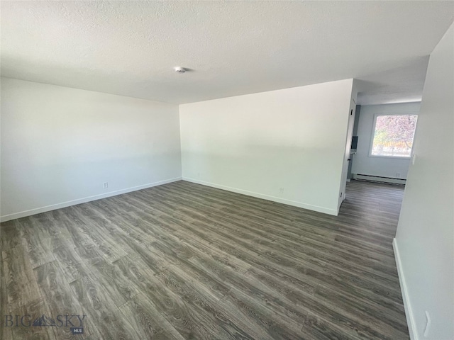 unfurnished room featuring a textured ceiling, wood-type flooring, and a baseboard radiator