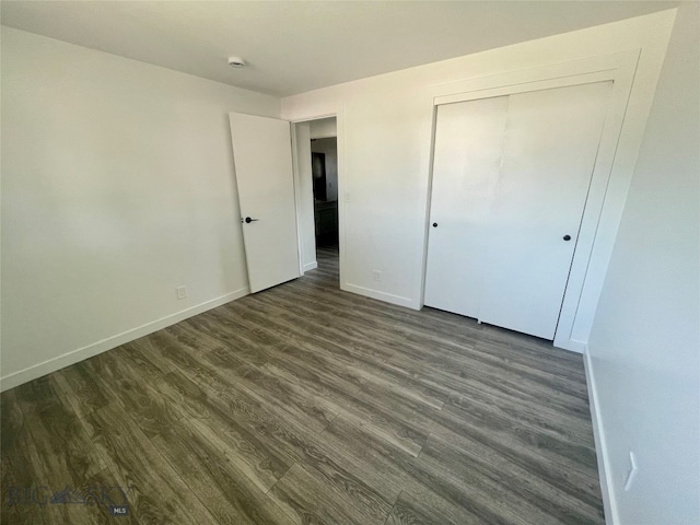 unfurnished bedroom featuring hardwood / wood-style floors and a closet