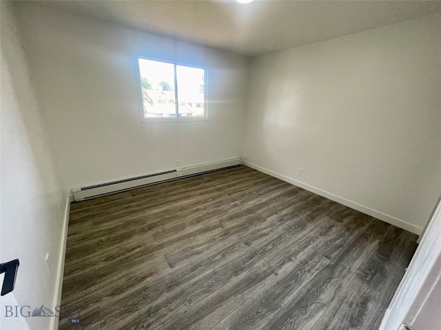 spare room featuring wood-type flooring and a baseboard radiator