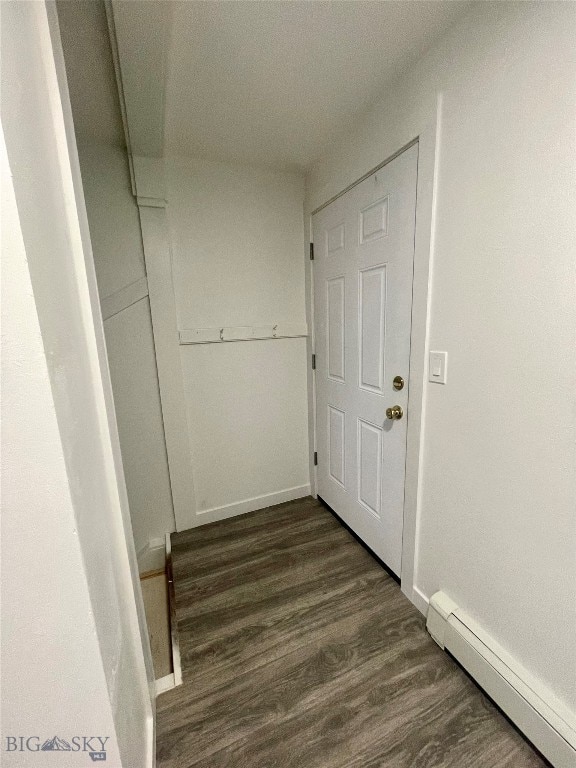 hallway featuring dark hardwood / wood-style flooring and baseboard heating