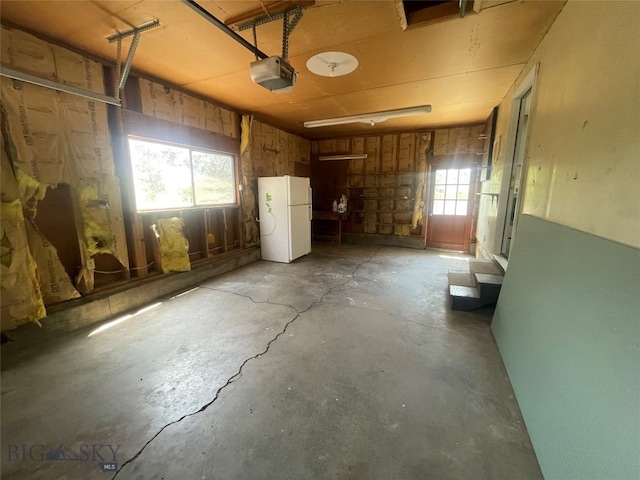 garage with white refrigerator and a garage door opener