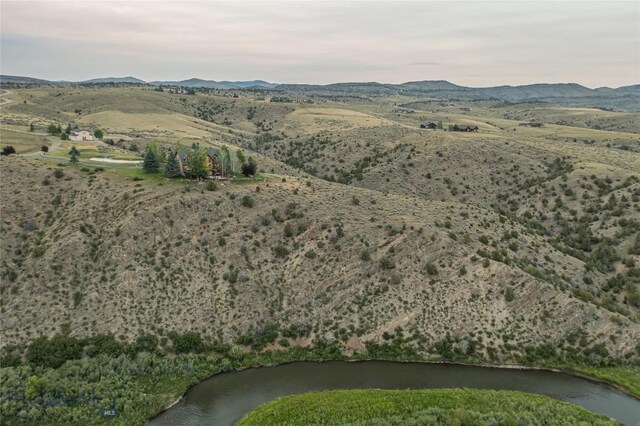 aerial view featuring a water and mountain view