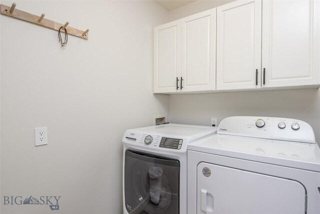 washroom with independent washer and dryer and cabinets