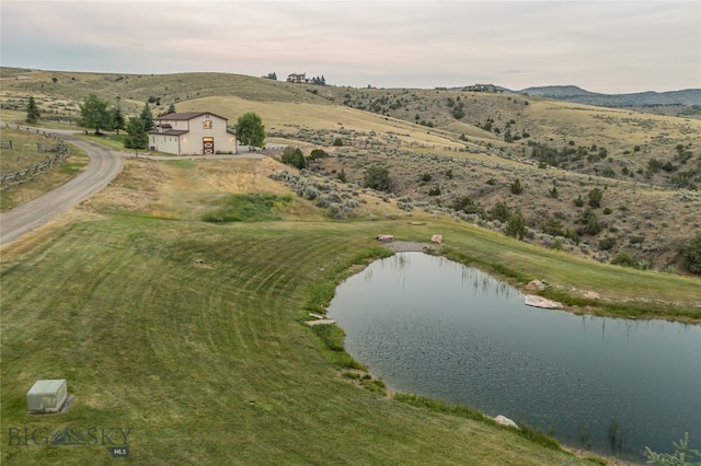 birds eye view of property featuring a water view and a rural view