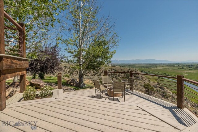 deck with a mountain view and a rural view