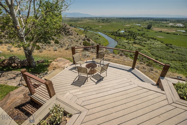 wooden terrace featuring an outdoor fire pit