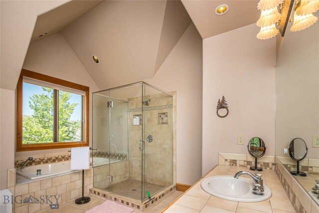 bathroom featuring tile patterned flooring, shower with separate bathtub, and sink