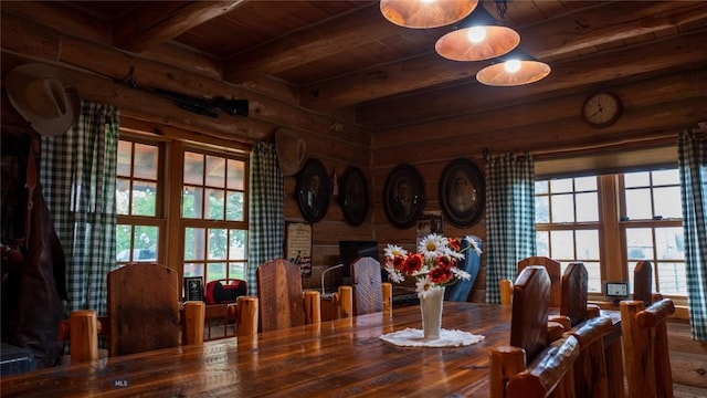 dining space featuring wood ceiling, beam ceiling, and a brick fireplace