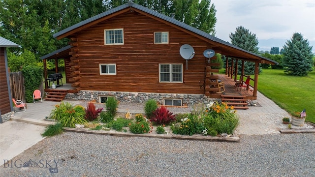 view of home's exterior featuring a patio, a deck, and a lawn