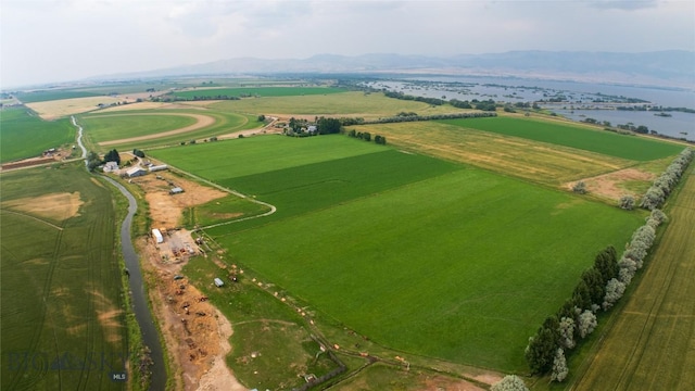 birds eye view of property with a rural view and a water and mountain view