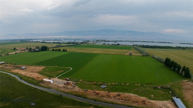 drone / aerial view with a rural view and a water and mountain view