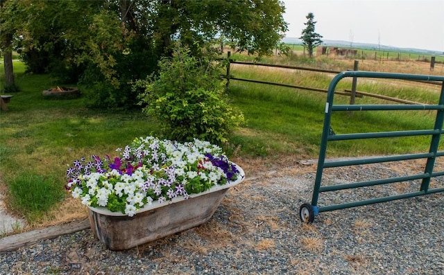 view of gate with a rural view