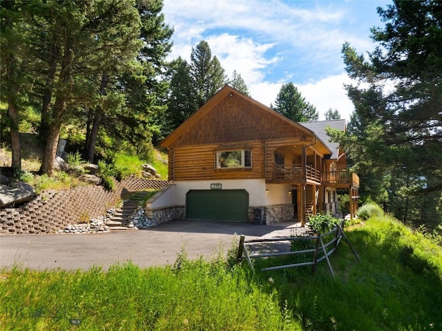 exterior space featuring a wooden deck and a garage