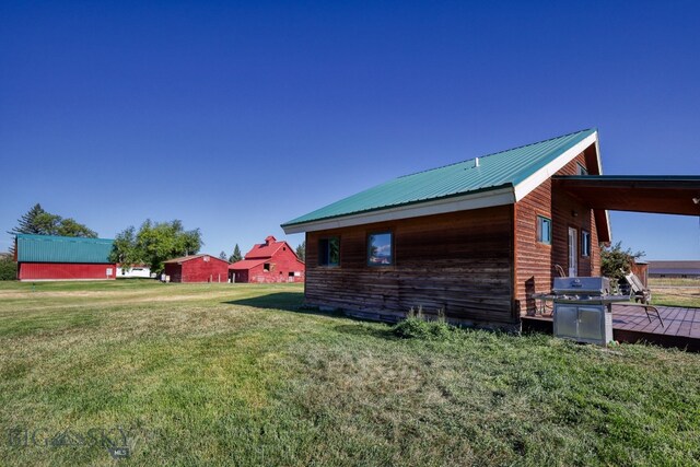 view of home's exterior with a yard and a wooden deck