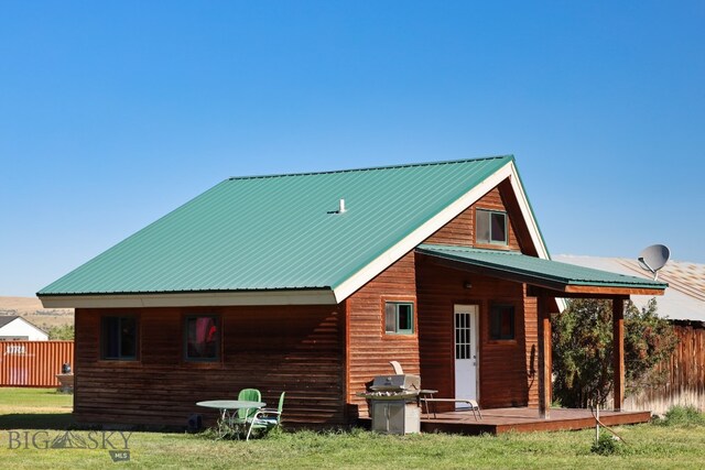 rear view of property featuring a yard