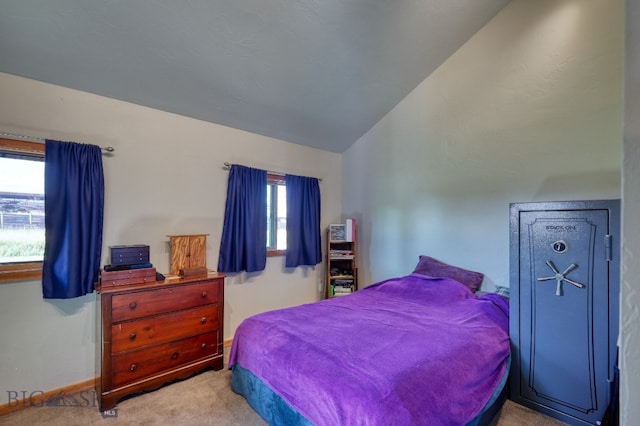 carpeted bedroom with lofted ceiling