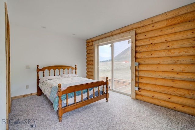 224 Slide Rock Rd, Cameron, MT 59720 - carpeted bedroom with rustic walls, access to exterior, and baseboards
