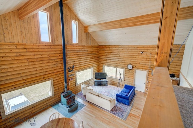 224 Slide Rock Rd, Cameron, MT 59720 - living area with plenty of natural light, a wood stove, log walls, and high vaulted ceiling