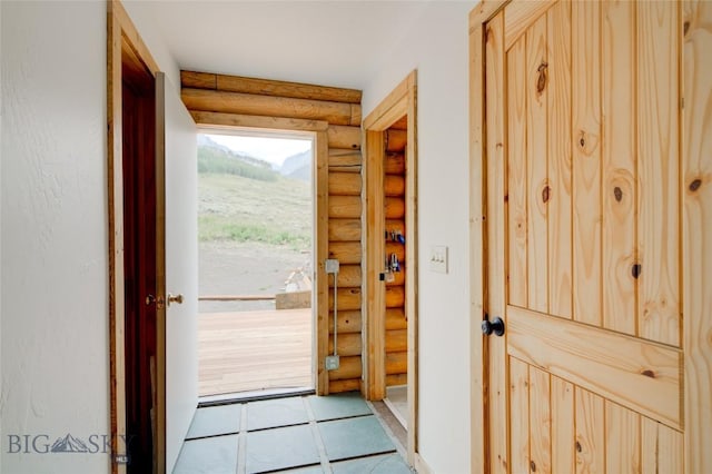 224 Slide Rock Rd, Cameron, MT 59720 - entryway with tile patterned flooring and rustic walls