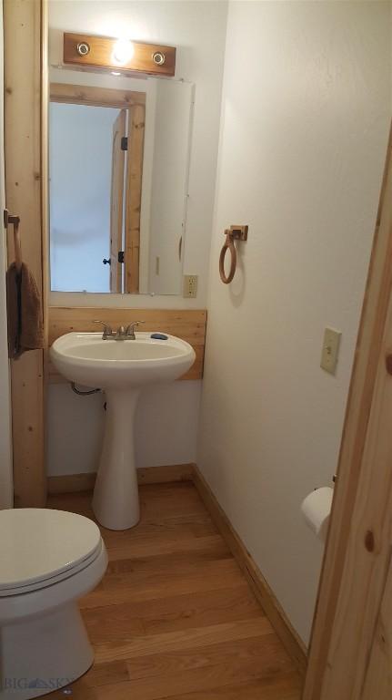 224 Slide Rock Rd, Cameron, MT 59720 - half bathroom with baseboards, toilet, and wood finished floors