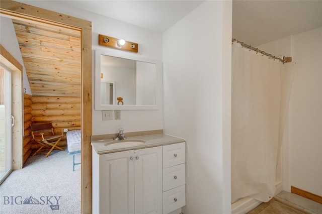 224 Slide Rock Rd, Cameron, MT 59720 - bathroom featuring a shower with curtain, wooden ceiling, vanity, baseboards, and rustic walls