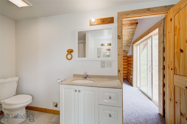 224 Slide Rock Rd, Cameron, MT 59720 - full bath featuring vanity, rustic walls, toilet, and a wealth of natural light