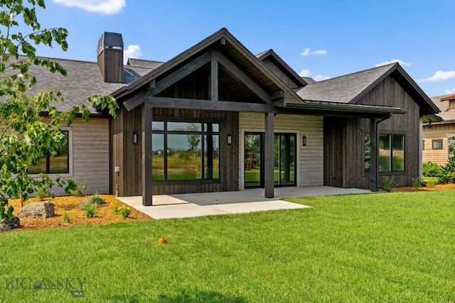 20 Bold Driver Ln, Bozeman, MT 59718 - back of house featuring a chimney, a yard, roof with shingles, and a patio area