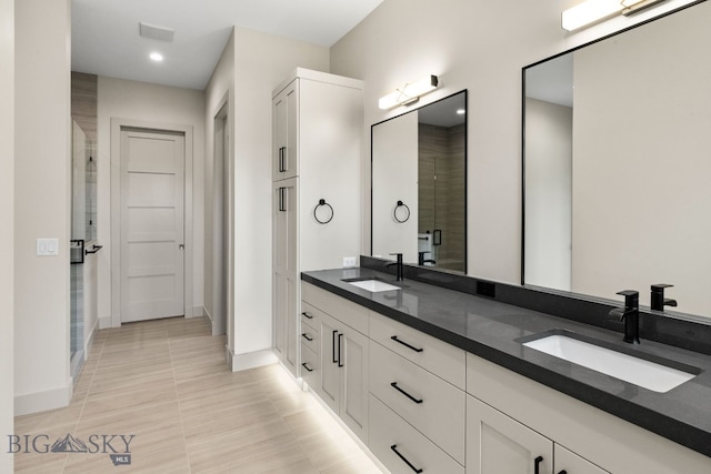 20 Bold Driver Ln, Bozeman, MT 59718 - bathroom featuring a stall shower, double vanity, baseboards, and tile patterned flooring