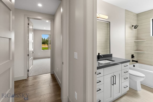 20 Bold Driver Ln, Bozeman, MT 59718 - bathroom featuring vanity, recessed lighting, wood finished floors, toilet, and shower / bathtub combination