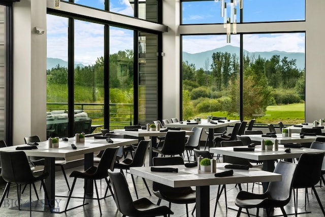 dining area featuring a mountain view and floor to ceiling windows