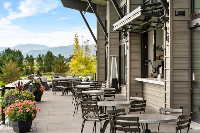 view of patio featuring outdoor dining area, outdoor lounge area, and a mountain view