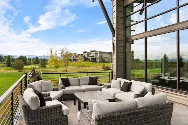 wooden terrace featuring an outdoor living space and a yard