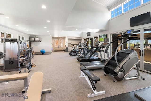exercise room with recessed lighting, a towering ceiling, and carpet floors