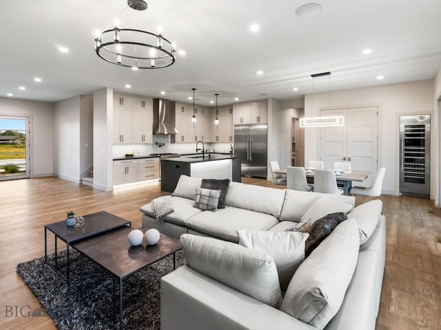 20 Bold Driver Ln, Bozeman, MT 59718 - living room featuring wine cooler, recessed lighting, baseboards, light wood finished floors, and a chandelier