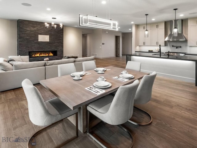 20 Bold Driver Ln, Bozeman, MT 59718 - dining space featuring baseboards, recessed lighting, light wood-style flooring, and a stone fireplace