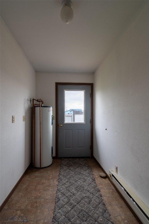 entryway with water heater, a baseboard heating unit, and tile patterned flooring