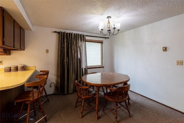 carpeted dining area featuring a chandelier and a textured ceiling