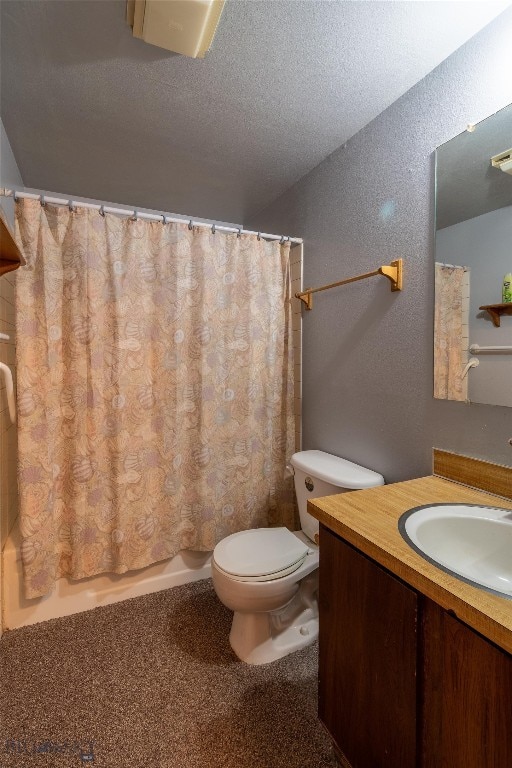 bathroom featuring vanity, a textured ceiling, and toilet