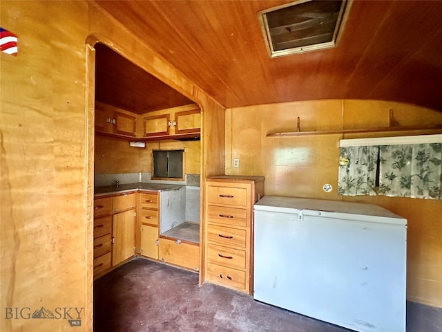 kitchen with refrigerator, wood walls, and wood ceiling