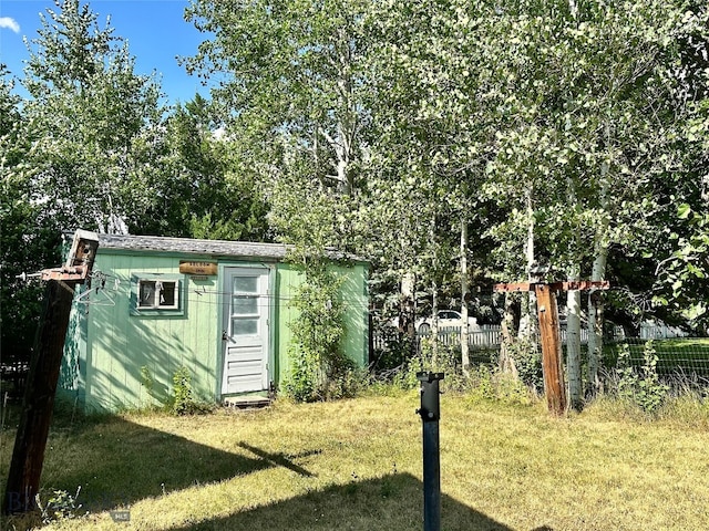 view of outbuilding with a yard