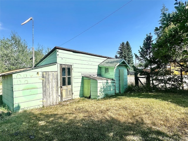 view of outbuilding with a yard