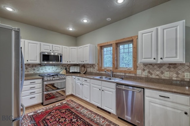 83 W Pine Cone Ter, Big Sky, MT 59716 - kitchen featuring appliances with stainless steel finishes, a sink, light wood-type flooring, white cabinetry, and recessed lighting