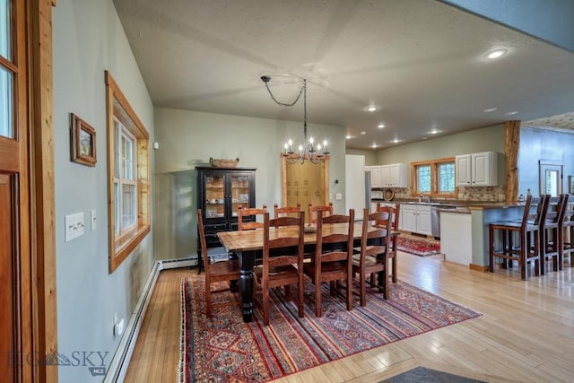 83 W Pine Cone Ter, Big Sky, MT 59716 - dining room featuring light wood finished floors, a chandelier, recessed lighting, and baseboards
