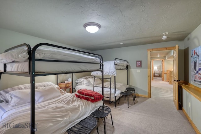83 W Pine Cone Ter, Big Sky, MT 59716 - bedroom with carpet, a textured ceiling, and baseboards