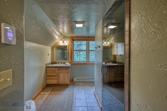 83 W Pine Cone Ter, Big Sky, MT 59716 - bathroom with baseboard heating, a textured wall, vanity, lofted ceiling, and a textured ceiling