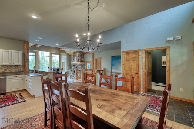 83 W Pine Cone Ter, Big Sky, MT 59716 - dining area featuring a chandelier, a baseboard heating unit, vaulted ceiling, recessed lighting, and baseboards