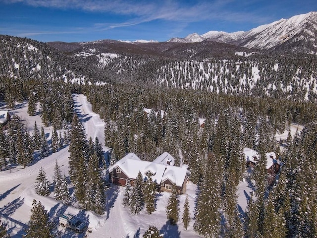 83 W Pine Cone Ter, Big Sky, MT 59716 - snowy aerial view featuring a mountain view and a wooded view