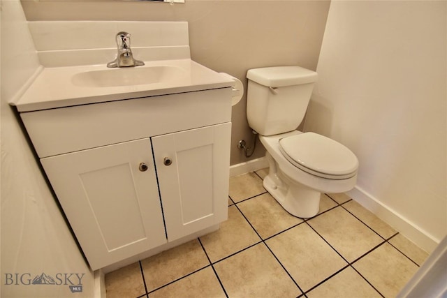 half bath featuring toilet, tile patterned flooring, baseboards, and vanity